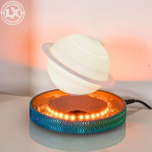 Saturn globe hovering in midair over the lit magnetic base