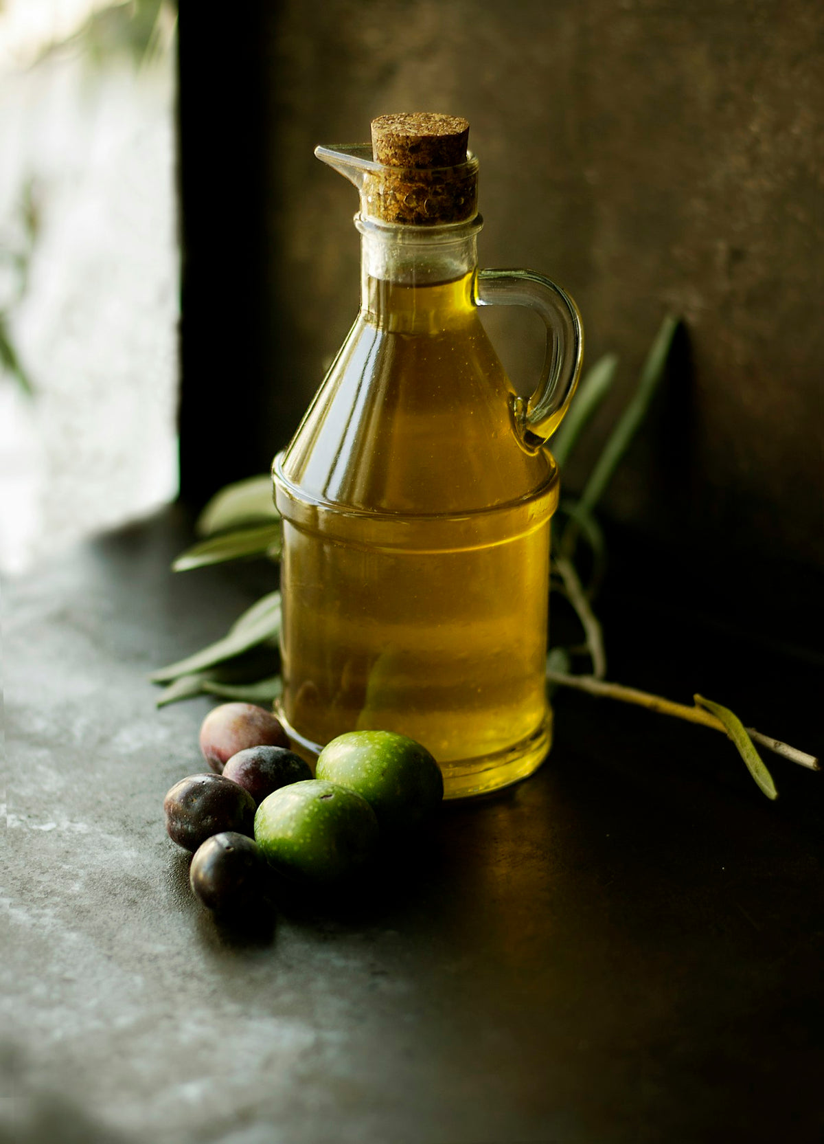 Unbranded glass carafe of golden cooking oil