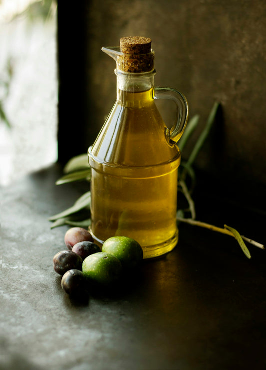 Unbranded glass carafe of golden cooking oil